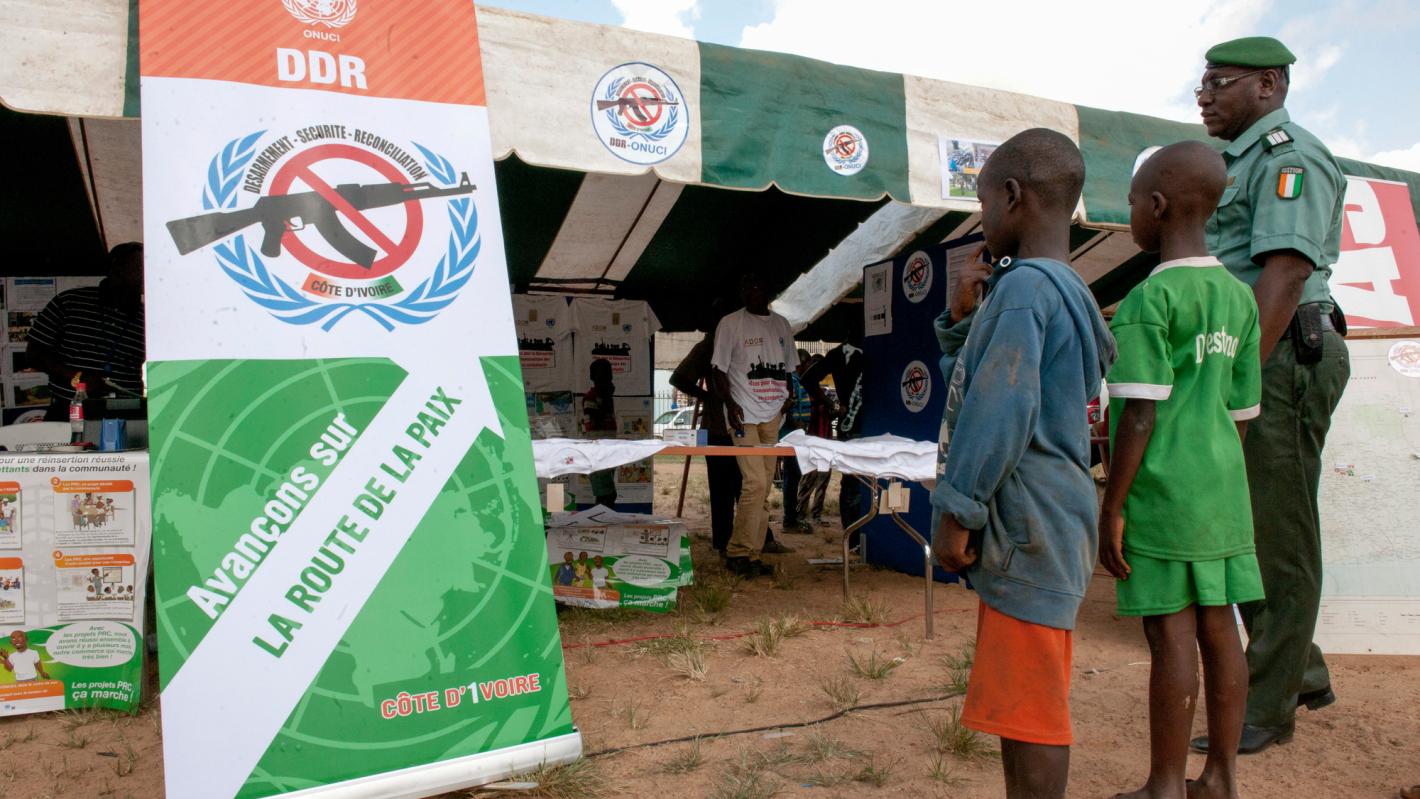 Children facing a sign