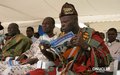 UNOCI Forum in Anyama in July 2007:  a traditional chief reads the Mission's newsletter 