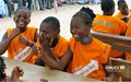 Schoolgirls celebrating the rights answers at a quiz organized by UNOCI during a sensitization caravan in Adjame (Abidjan) in March 2012 ((Photo UNOCI/Macline Hien)